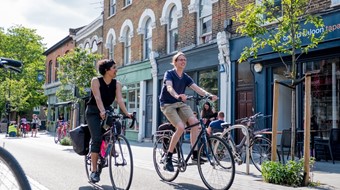 Male and female coworkers cycling side by side